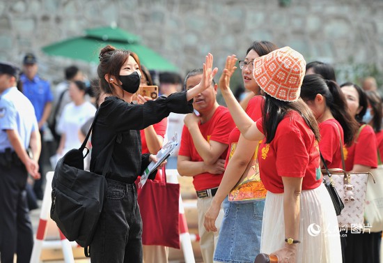 6月7日，北京市第九中學(xué)考點，考生與送考家長擊掌加油。人民網(wǎng)記者 於凱攝