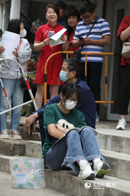 6月7日，沈陽市第一中學(xué)，學(xué)子靠在父親身邊做最后的沖刺。人民網(wǎng) 周頌雪攝